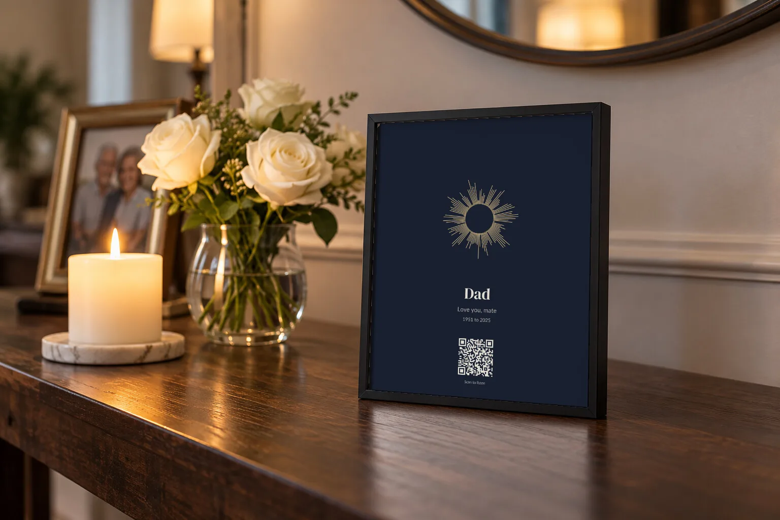 A midnight blue voice print for Dad on a hallway table beside a candle and white roses